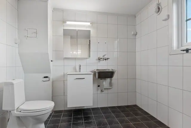 Bad i 1 etasje med opplegg for vaskemaskin og tørketrommel.