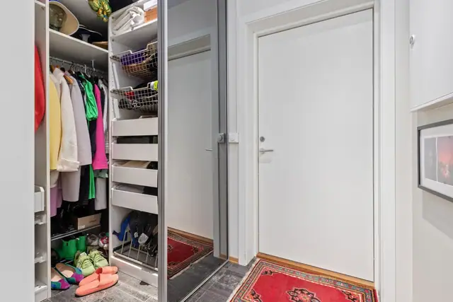 Inngangsparti med skyvedørsgarderobe.